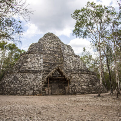 Looking behind the trees at the beautiful Mayan Pyramid in Coba, Mexico